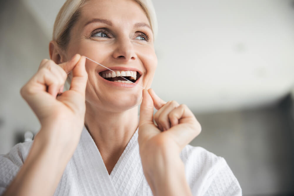 cleaning teeth with floss