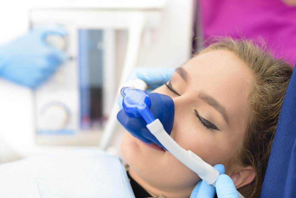 Beautiful woman inhalation sedation at dental clinic